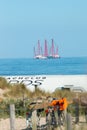 dutch beach cafe tent with heavy industry maritime barge off the coast Royalty Free Stock Photo