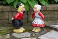 A Dutch boy and girl lawn ornaments standing with wooden shoes and traditional dutch clothes from the Netherlands in Europe Royalty Free Stock Photo