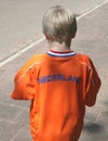 Dutch boy in orange suit for Kingsday (Koningsdag) and soccer events, Netherlands