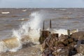 Dutch breakwater with breaking wave in heavy storm