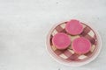 Dutch cake with pink frosting, called Roze Koek, against white grey backgruond