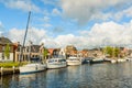 Dutch canal with moored boats on the shore, city of Lemmer