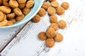 Dutch candy pepernoot with bowl on wooden background