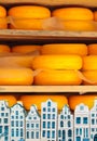 Dutch cheese with Delft souvenir houses in front Royalty Free Stock Photo