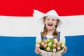 Dutch child with tulip flowers and Netherlands flag
