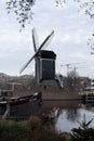 Dutch city Leiden in autumn. Windmill and old boat Royalty Free Stock Photo