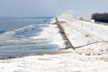 Dutch coast with wind turbines in wintertime and frozen sea Royalty Free Stock Photo