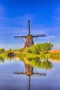 Dutch Destinations. Daytime View of Traditional Romantic Dutch Windmills in Kinderdijk Village in the Netherlands Before Sunset Royalty Free Stock Photo