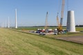 Dutch farmland with construction site of new wind turbines