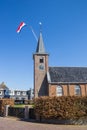 Dutch flag on the tower of the historic church in Eernewoude