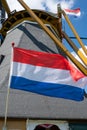 Dutch flag and traditional windmill used for grain grinding on backkground