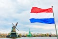 Dutch flag and windmill on canal Royalty Free Stock Photo