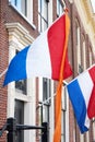 Dutch flags with orange streamer waving in the wind Royalty Free Stock Photo