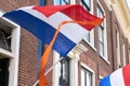 Dutch flags with orange streamer waving in the wind Royalty Free Stock Photo