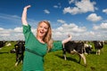 Dutch girl happy in field with cows