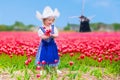 Dutch Girl In Tulip Field In Holland