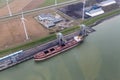Dutch harbor Eemshaven with wind turbines and and freighter transporting coals Royalty Free Stock Photo