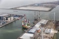 Dutch harbor Eemshaven with wind turbines and offshore construction platforms Royalty Free Stock Photo