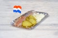 Dutch snack, seafood sandwich with herring, onions and pickled c Royalty Free Stock Photo