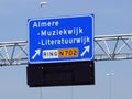 Dutch highway exit sign for Almere Muziekwijk and Literatuurwijk. Royalty Free Stock Photo