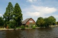 Dutch house, garden, canal and trees