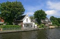 Dutch houses, boat, canal and trees Royalty Free Stock Photo