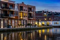 Dutch houses at the canal by night, City architecture of Alphen aan den Rijn, the Netherlands