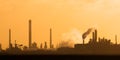 Dutch industrial plant with chimneys and windmill during sunset in Europoort, Rotterdam Royalty Free Stock Photo