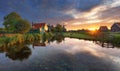 Dutch landscape with windmill at dramatic sunset, Zaandam, Amsterdam, Netherlands Royalty Free Stock Photo