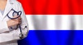 Dutch medicine and healthcare concept. Doctor close up against flag of Netherlands background