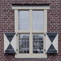 Dutch medieval design window pane with wooden shutters Royalty Free Stock Photo