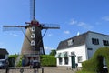 A dutch mill with a house next to it