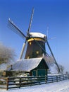 A Dutch mill in a winter landscape Royalty Free Stock Photo