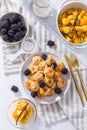 Dutch mini pancakes called poffertjes with blackberries and apple compot