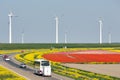 Dutch motorway near lelystad along colorful tulip fields and windturbines