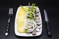 Dutch national appetizer, herring with onions. Tasty pieces of Icelandic herring with boiled potatoes and onions on the plate.