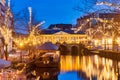 The Dutch Oude Rijn canal with bridge, historic buildings and christmas lights in the city center of Leiden