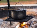 Dutch oven over a campfire, cooking at the campsite Royalty Free Stock Photo