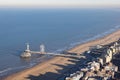 Dutch pier Scheveningen with long shadows Kurhaus at the beach Royalty Free Stock Photo