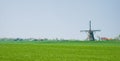 Dutch polder landscape with mill and farms Royalty Free Stock Photo