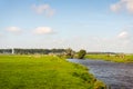 Dutch polder landscape with a wide ditch for drainage purposes