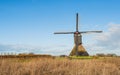 Dutch polder mill against a blue sky Royalty Free Stock Photo