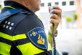 Dutch policeman with radio .Focus on badge with logo Royalty Free Stock Photo