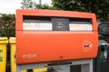 Dutch post office postal box in the street. Orange in colour