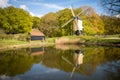 Dutch post windmill with reflection in the water