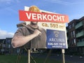Dutch real estate billboard sign stating that a building spot is sold.