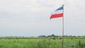 Dutch red white and blue upside down flag in an agricultural field