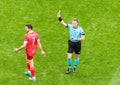 Dutch referee Danny Makkelie showing a yellow card to Russia midfielder Magomed Ozdoyev during EURO 2020 match Finland vs Russia Royalty Free Stock Photo