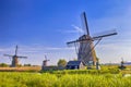 Dutch Romantic Destinations. Daytime View of Traditional Romantic Dutch Windmills in Kinderdijk Village in the Netherlands Before Royalty Free Stock Photo