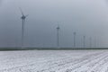 Dutch rural landscape with wind turbines in winter haze